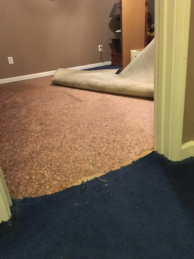 Carpet pad removal revealing water damage during Water Mitigation Services in Kahaluu